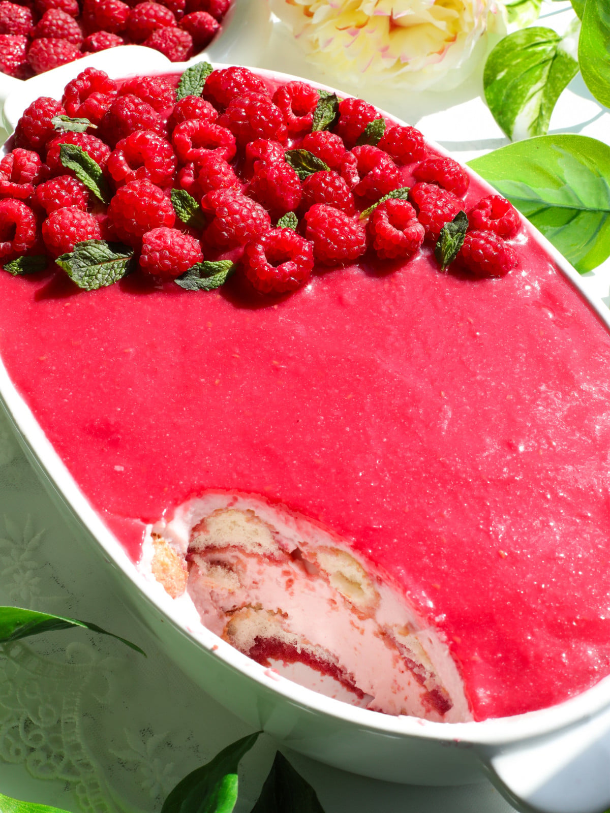 No-egg raspberries tiramisu in a white oval dish.