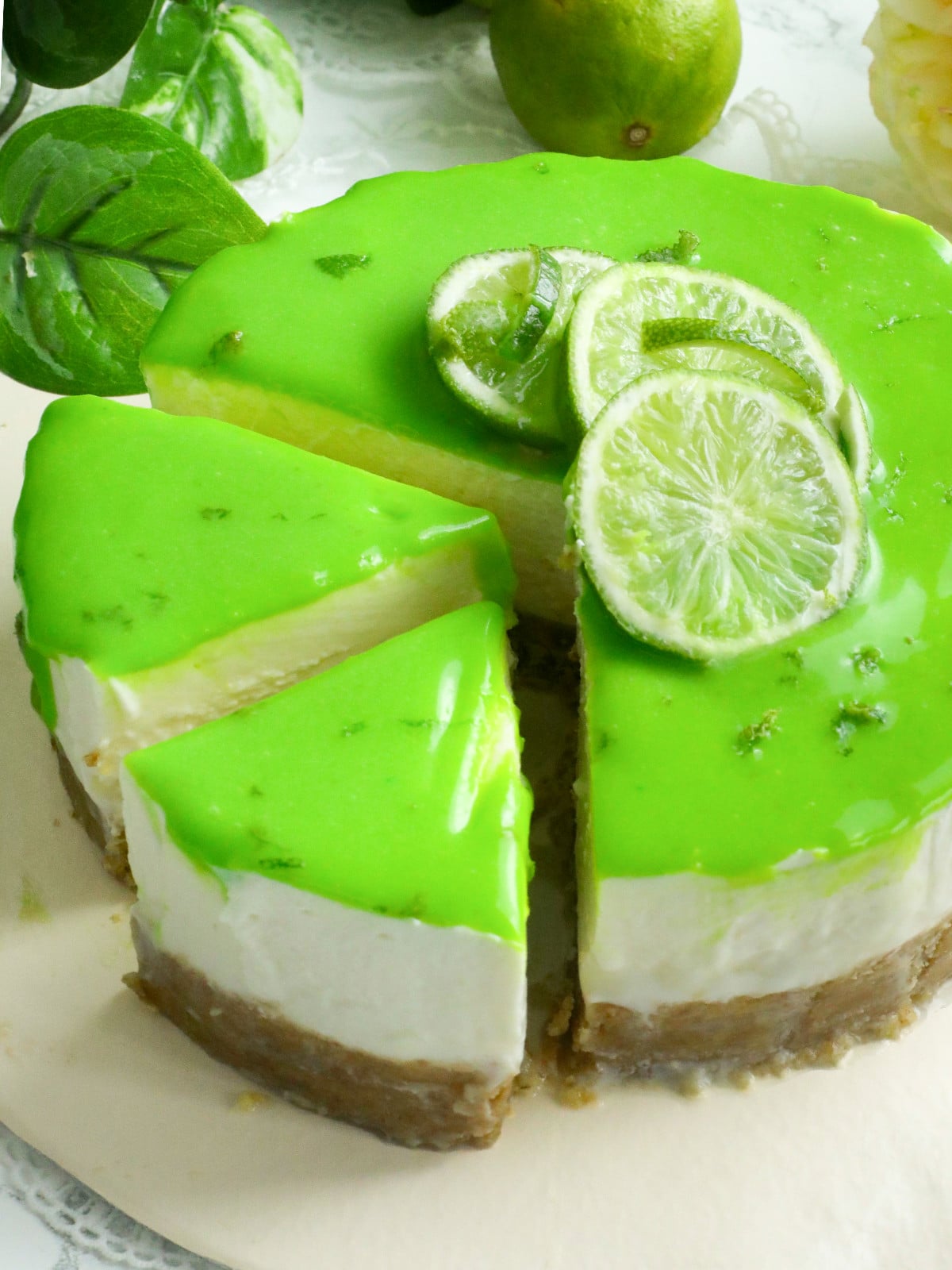 Lime cheesecake on a cream board.