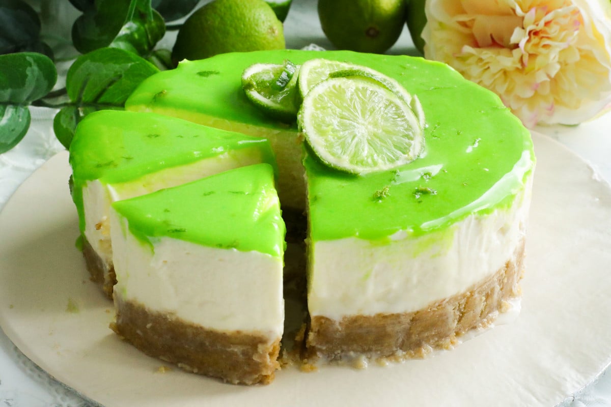 Lime cheesecake sliced on a board.