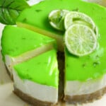 Lime cheesecake with lime curd topping on a cream board.