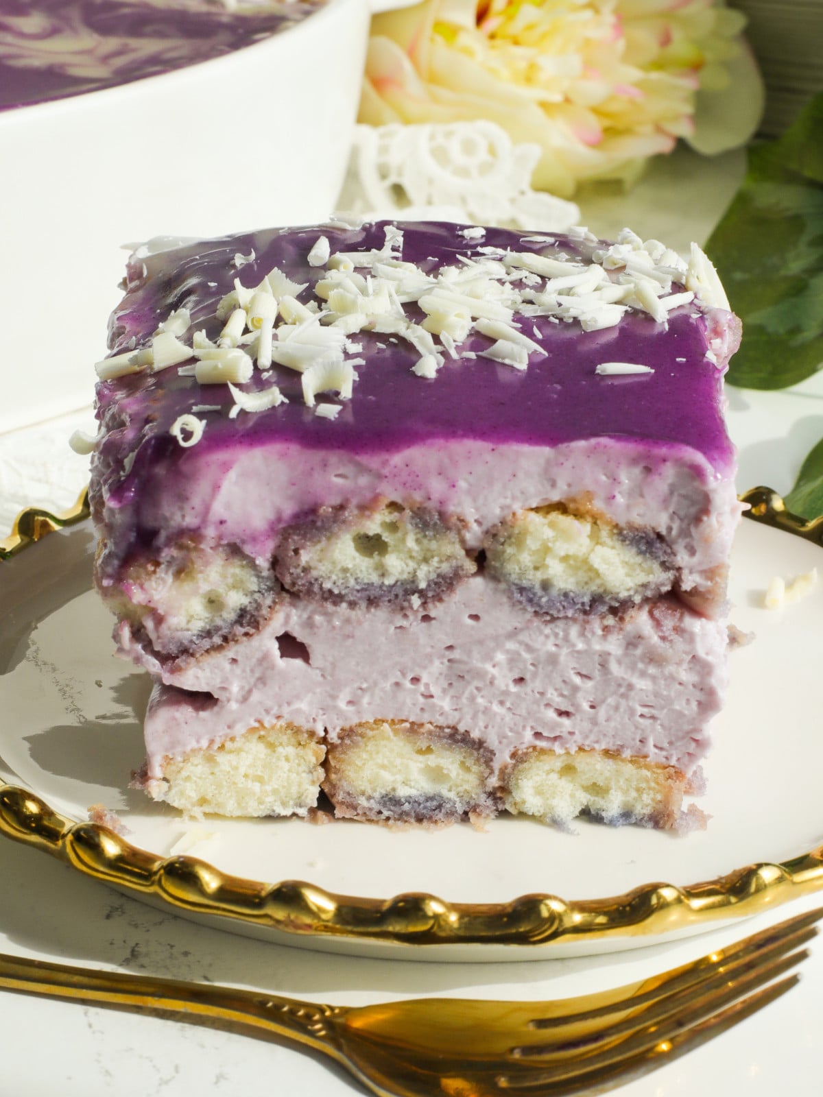 Ube infused tiramisus on a white and gold plate.