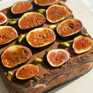 Fig chocolate mousse on a beige board.
