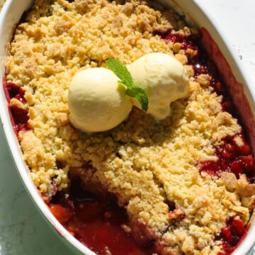 Plums crumble inn a white dish.
