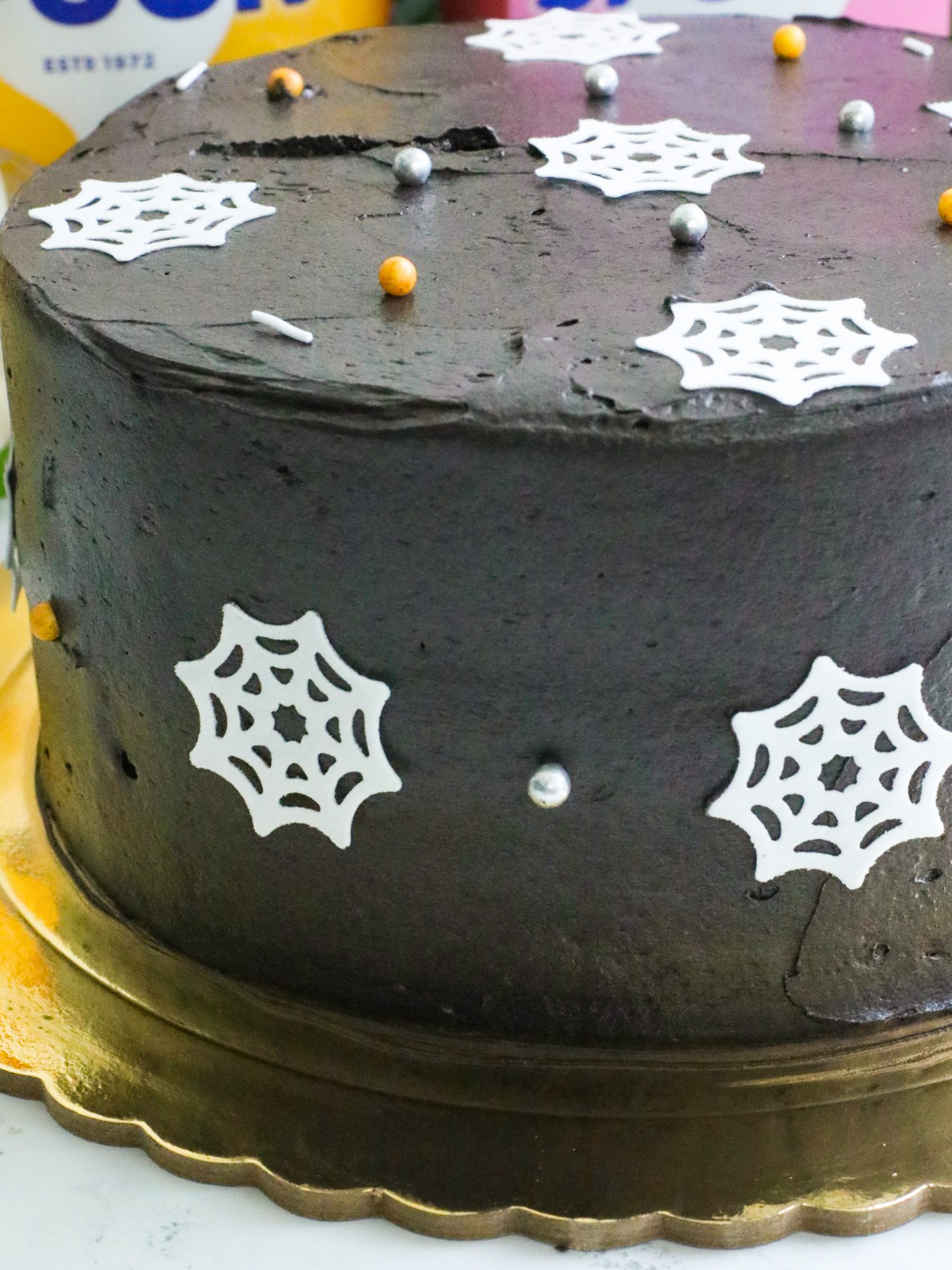 Black cake on a gold board.